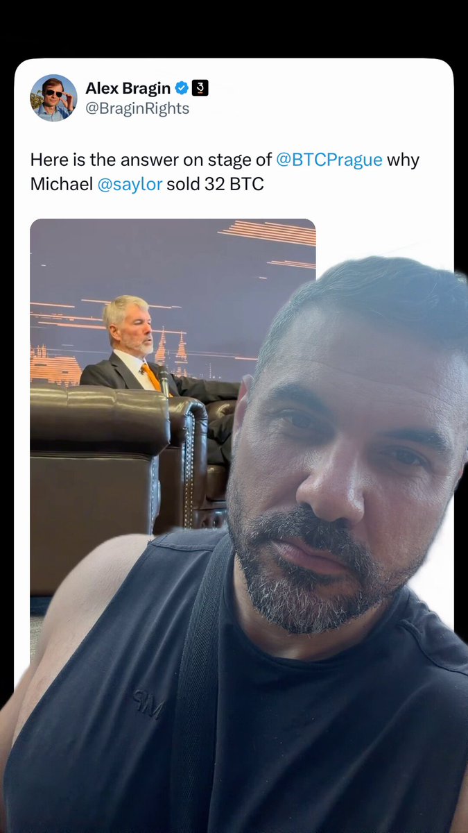 The image features a man wearing a black shirt, sitting down with his head tilted back while looking at the camera. The background of the photo shows another person sitting on a couch, which appears to be brown. There are also some text elements visible in the image, including "Saylor says" and "I said for YOU to never sell your bitcoin".