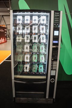 The image features an electronic vending machine that dispenses Trezors, which are small electronic devices used for charging cell phones. The machine has a green background and white text, indicating its purpose as a Trezor dispenser. There are multiple Trezors visible on the machine, suggesting it is in use or about to be used by customers.

The post also mentions Bitcoin, which is a digital currency that can be used for purchasing items from the vending machine. The image includes a Bitcoin address and a Bitcoin symbol, indicating that the vending machine accepts Bitcoin as payment.