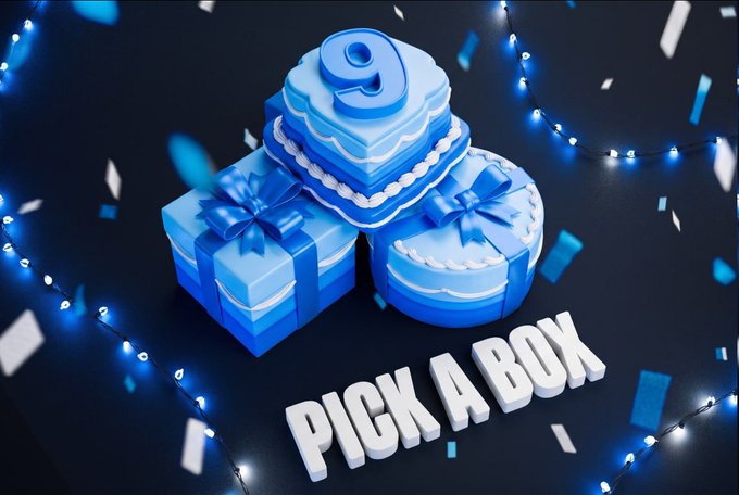 A festive promotional graphic featuring three blue gift boxes (heart, square, and round shapes) topped with the number "9" and the text "PICK A BOX," surrounded by glowing string lights and falling confetti on a dark background. The image ties to the Telegram giveaway by inviting viewers to choose a gift box color for a chance to win a share of $10,000.
