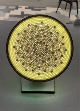 The image features a unique piece of artwork called "Mnemonic Geometry", created by artist @BTCPrague. It's displayed on a glass stand, which makes it easily visible for those interested in art and technology. The artwork is available at an auction, and the time to bid should end soon. As the auction begins, make sure you focus on the piece of art and its details. Don't miss the opportunity to support @BTCPrague's creative talent by acquiring this intriguing artwork from the auction.