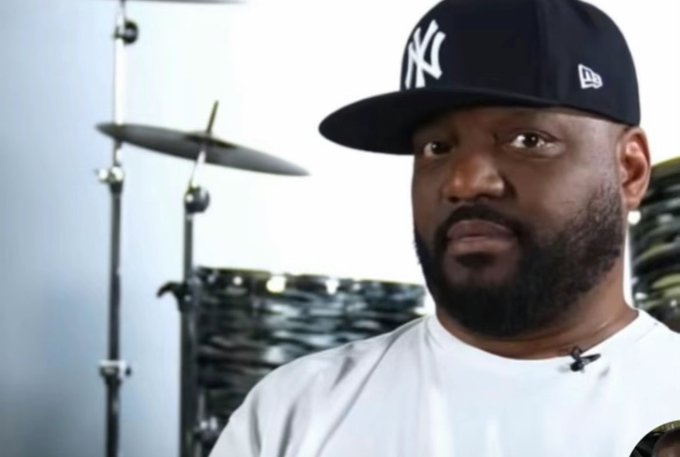 The image features a man wearing a black baseball cap with a white "NY" logo, standing next to a drum set. The drum set consists of multiple drums placed at various positions around the room. In the background, there are stacks of CDs or records, which could be related to music production or storage. The post appears to discuss the collapse of the cryptocurrency Zcash and its connection to Bitcoin, with an emphasis on the ethical implications of investing in it.