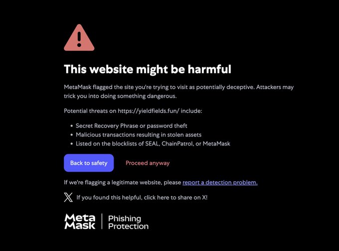 A screenshot of a MetaMask phishing protection warning alerting users that "yieldfields.fun" has been flagged as harmful due to risks of seed phrase theft and malicious transactions.