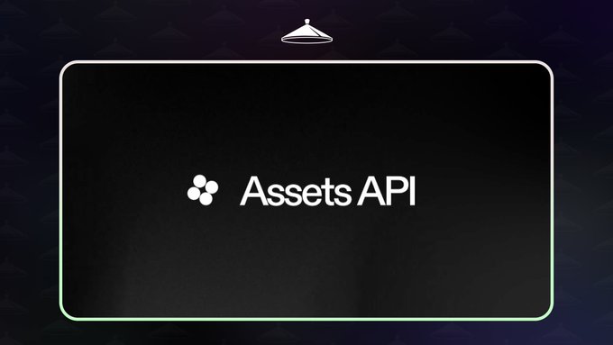 The image features a black square that displays the text "ASSETS API" written in white letters. The background of the image is dark, which contrasts with the white text. There are also some small circles scattered throughout the image.