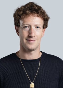 The image shows a man with curly red hair wearing a dark sweater and a gold pendant necklace, posing against a plain light background in what appears to be a professional headshot. The accompanying post discusses web2 handle models and the Muse band, seemingly unrelated to the image, which resembles a publicity-style portrait but does not contain any visible text or identifiers connecting it to the post's content.