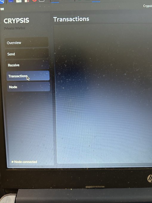 A photograph of a computer screen displays the Crypsis Private Wallet interface, showing a cursor hovering over the 'Transactions' tab on the left navigation menu.