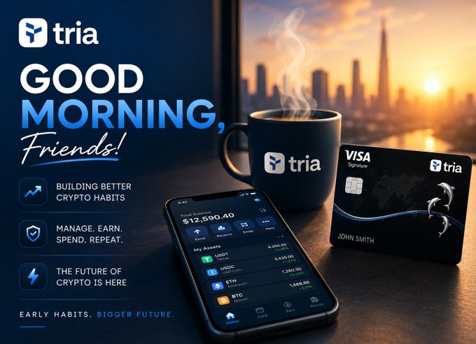 The image features a cell phone with an app called @useTria displayed on its screen. The phone is placed next to two credit cards - one from Tria and another from Visa. The text "Good morning friends!" is written above the phone, indicating that the user has just received their morning coffee or tea. This suggests that the image is related to a post about using cryptocurrency apps in the morning routine, as it highlights how @useTria can be an essential part of one's daily life and thinking about crypto.