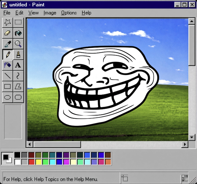 A screenshot of Microsoft Paint displays a classic "Trollface" meme illustration edited onto the iconic Windows XP "Bliss" wallpaper (green rolling hills beneath a blue sky with clouds). The window title reads "untitled - Paint," connecting directly to the post's reference of $TROLL being drawn in this nostalgic, simple editing environment.