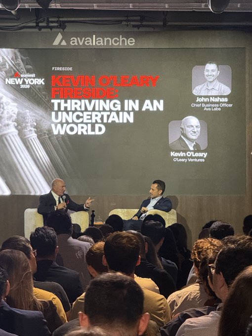 A fireside chat at the Avalanche Summit New York 2026 titled 'Kevin O'Leary Fireside: Thriving in an Uncertain World,' featuring John Nahas (Chief Business Officer, Ava Labs) interviewing Kevin O'Leary (O'Leary Ventures) on stage before an audience.