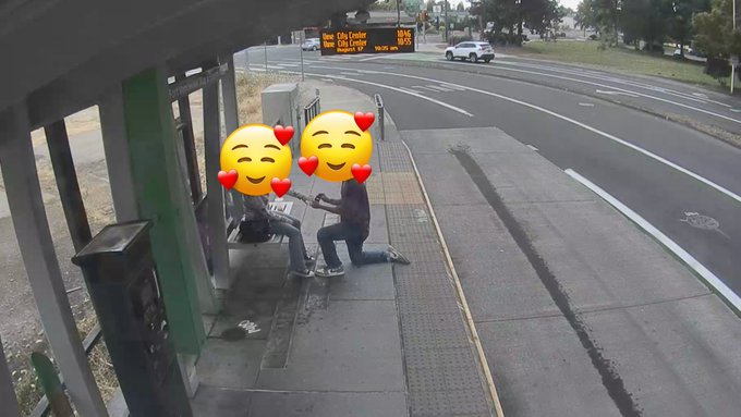 Two people share an intimate moment on a bus stop bench, faces covered by heart-eyed emojis, while a digital sign in the background displays "Brisbane" along with traffic times of 8 minutes to City Centre and 11 minutes to UQ, symbolizing the quiet authenticity that emerges after social media hype fades.