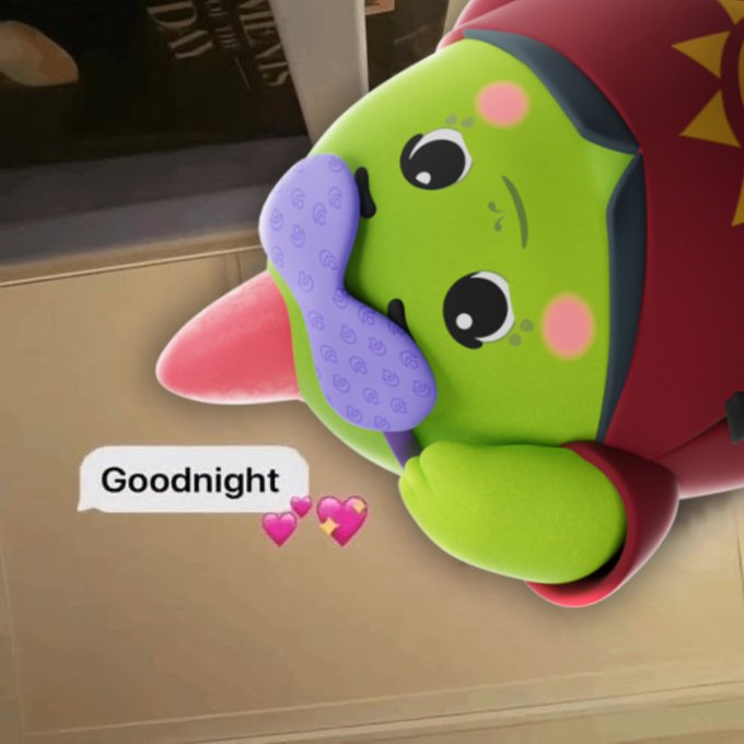 urn of gold and red flowers, with a green frog wearing a purple mask and holding a pink heart on its forehead.