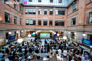 A large group of attendees gathers in a multi-story brick atrium at the Solana Shanghai Builders Assembly, seated at round tables for the event. The image visually supports the post's message of community appreciation, showing the scale of builders who came together for the gathering.