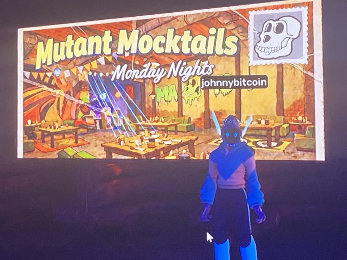 A screenshot from a virtual event or game titled 'Mutant Mocktails Monday Nights' by johnnybitcoin, showing a virtual avatar in blue and pink attire standing before a projected banner depicting a lively tavern scene.