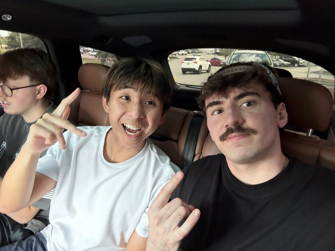 Three young men sit inside a car, with the two in front flashing hand signs and grinning at the camera while parked in a lot, matching the caption's hyped "takeover" energy for an upcoming event with @SolLunix.