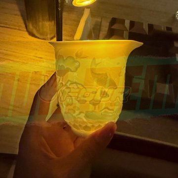 A hand holds a yellow cup with a bear design under a warm light, with the Korean text "바닐라라떼" (Vanilla Latte) displayed on the image.
