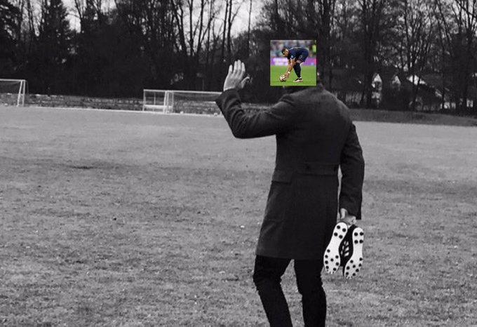 A person in a black coat stands on a grassy field with their back to the camera, holding up a small screen showing a soccer player about to kick a ball, while also holding a pair of cleats in their other hand. The image humorously suggests the person is "watching" or reacting to a soccer moment—possibly connecting to the post about cashing in a big Polymarket bet, as if celebrating a winning prediction on a soccer match outcome.