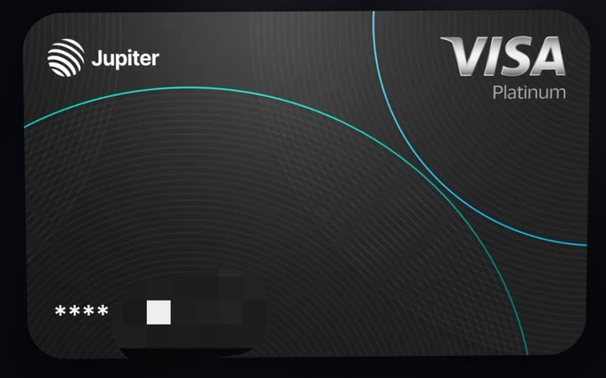 The image features a black rectangular Visa card with a white border. The card has a unique design, featuring blue circles that create a spiral pattern across its surface. The text "JUPITER VISA PLATINUM" is written on the card in white letters. The card appears to be new and unused, as indicated by the lack of any visible transactions or personal information.