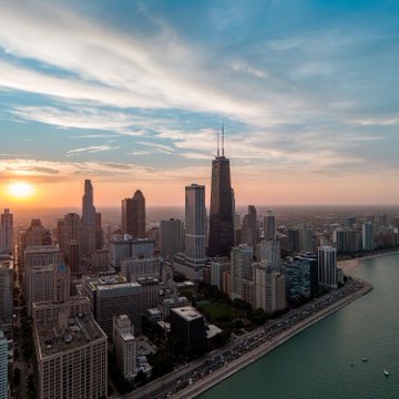 A Chicago skyline at sunset, featuring the Willis Tower and Lake Michigan, is shown as a backdrop to news that Illinois has agreed to delay its Digital Asset Tax until July 1, 2027, in a joint motion with crypto industry groups.