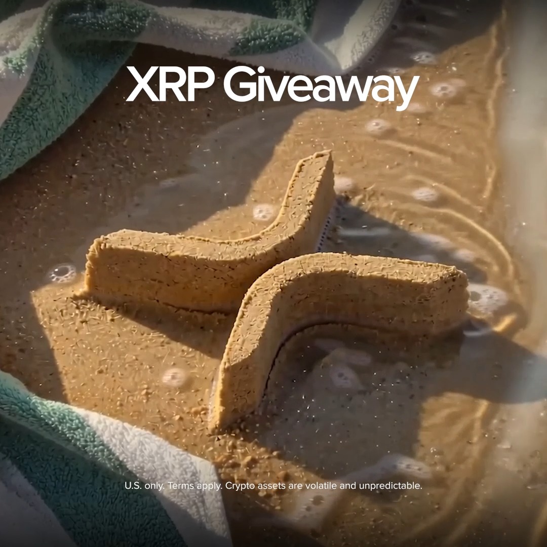 The image features a sandcastle, which has been made using two large blocks of sand placed together with an x shape. The text "XRP Giveaway" is written above the sandcastle, indicating that there's a contest going on for XRP tokens. The text also mentions that five lucky followers will receive XRP in return for participating in this contest.