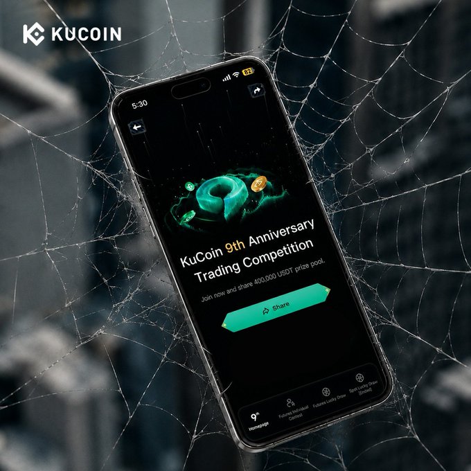 A smartphone entangled in spiderwebs displays a KuCoin app screen announcing the "9th Anniversary Trading Competition" with a 400,000 USDT prize pool and a "Share" button, set against a blurred urban backdrop with the KuCoin logo in the corner. The eerie spiderweb imagery reinforces the post's theme of a new challenge awaiting traders ready to compete.