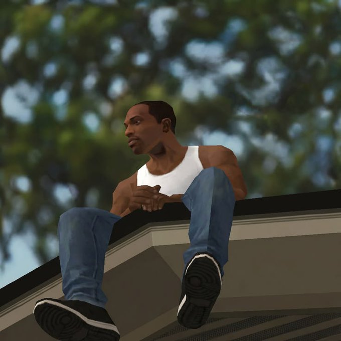 The image shows a man dressed in a tank top and blue jeans sitting on the edge of a roof or balcony. He has his feet hanging off the side as he looks out over the street below him, possibly observing market activity. The caption to the image includes information about a recent transaction on the liquidation machine and the current state of shorts being heavily penalized in real-time due to the market's swift movements. This indicates that there are sudden changes or fluctuations occurring, such as short price drops or high trading volumes for certain assets.