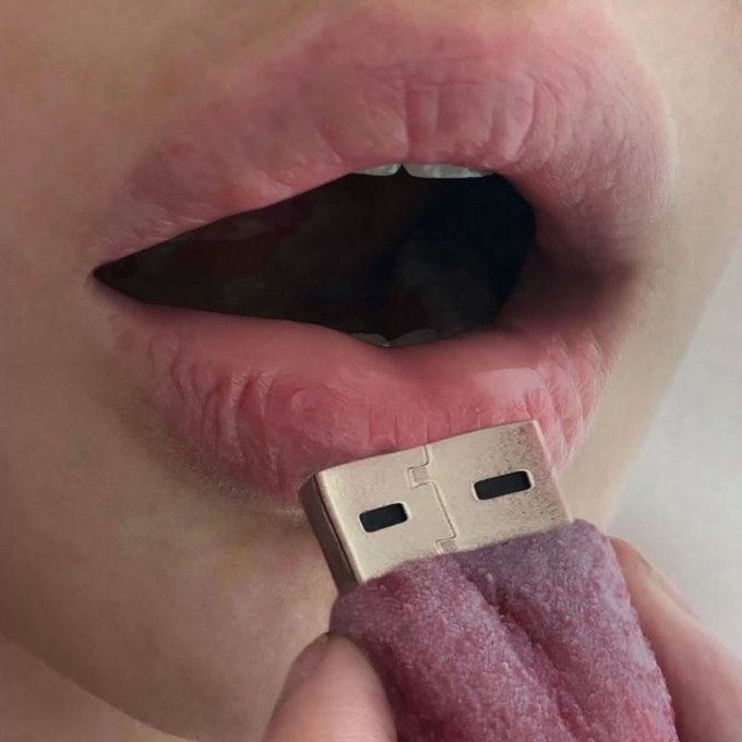 A close-up image shows a person holding a USB-A connector partially wrapped in fuzzy pink fabric near their open mouth, as if pretending to eat it.