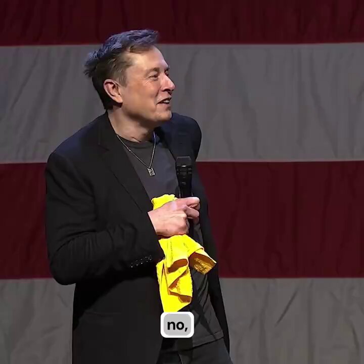 The image features an older man wearing a black suit jacket and holding a yellow towel over his shoulder while standing in front of an American flag backdrop. The caption reads "No", which could be interpreted as a humorous response or a statement about the current political climate.