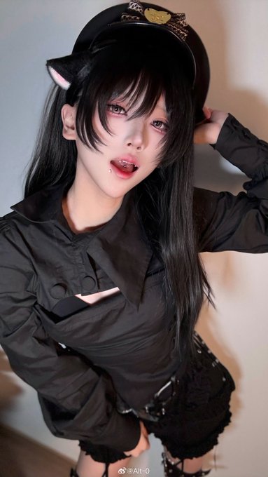The image shows a young woman with a goth aesthetic, wearing a black military-style cap with cat ears, a black blouse, and dark lace thigh-highs, with a lip piercing. The watermark "AI-0" (also stylized as "Alt-0" in the caption) at the bottom references the social media handle @AI-0.