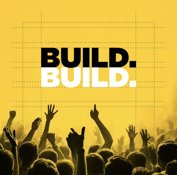 A vibrant yellow poster with bold "BUILD. BUILD." text above silhouetted fans with raised hands, visually capturing the unstoppable "24/7" grind and dedication of a community going all in around the clock.