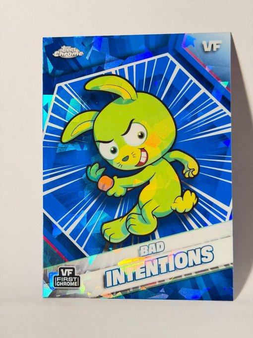 A holographic/foil trading card titled 'BAD INTENTIONS' featuring a green cartoon rabbit character holding an orange, part of the 'First Chrome!' series marked VF.