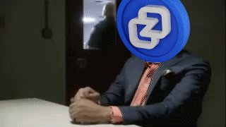 urn of blue liquid with a white "Z" logo, accompanied by a person wearing a black suit and red tie.