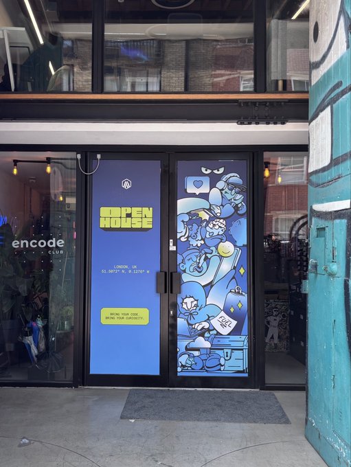 The entrance of 'Encode Club' features blue doors decorated with cartoon characters, a 'Ropen House' poster listing London coordinates (51.5072° N, 0.1276° W), and a graffiti-covered green wall on the right.