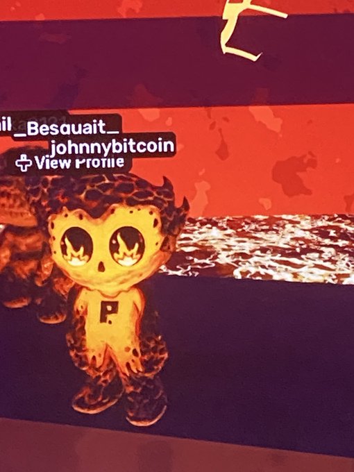 A digital avatar or character named '_Besaquait_johnnybitcoin' with a glowing yellow/orange appearance and large eyes, set against a fiery red background with a 'View Profile' option.