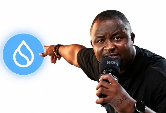 A man speaks into a Rode microphone while pointing toward a blue Sui cryptocurrency logo on a white background.