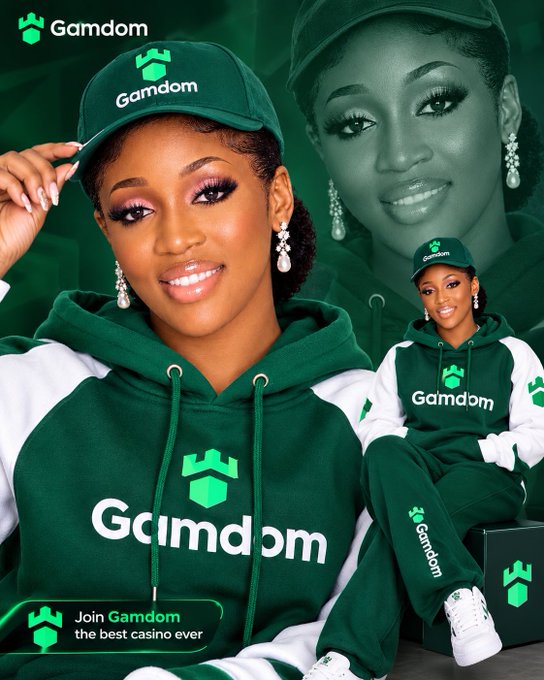 A promotional graphic for 'Gamdom' features a smiling woman wearing a green and white branded cap and hoodie, with the tagline 'Join Gamdom the best casino ever' displayed at the bottom.