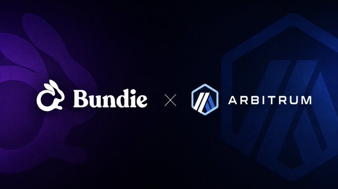 The image features a logo for Bundie Bundle, which is a cryptocurrency wallet that helps users earn yield while protecting their crypto. The logo includes two blue hexagons with the words "Bundie" and "Arbitrum" written on them in white letters. Below the logo, there's text that reads: "Bundie Bundle helps users earn yield while protecting their crypto. One deposit bundles yield strategies across protocols and chains, with an options overlay designed to reduce downside risk". The image also includes a caption that says "Focus on what is in the image and how it relates to the post".