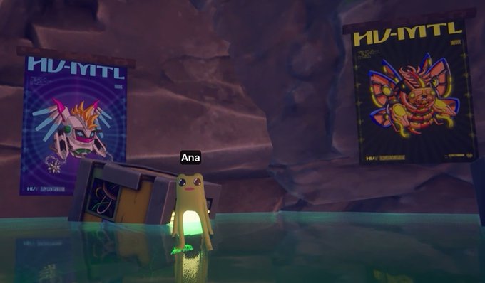 A digital avatar named 'Ana' stands in a virtual cave-like environment flanked by two glowing 'HU-MTL' banners featuring character illustrations.