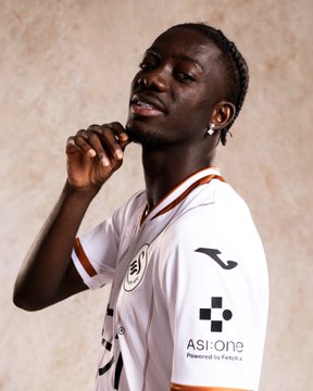 A proud footballer in a white and brown jersey, likely from Swansea City, poses with a confident smirk and a hand touching his chin. The jersey features the "ASI:ONE Powered by Fetch.ai" logo, which relates to the accompanying post's hashtags.