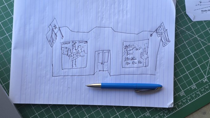 A hand-drawn sketch on lined notebook paper shows a design mockup for the "Plastic Cactus" independent artist exhibition booth, featuring panels labeled "THREADS OF THOUGHT" and "LENSES & ARTIFACTS... HOW YOU FEEL," with flags on either side and a blue pen resting on the page. The sketch appears to be an early concept for the booth layout being offered to artists interested in joining the ArtBlocks Marfa 2026 exhibition.