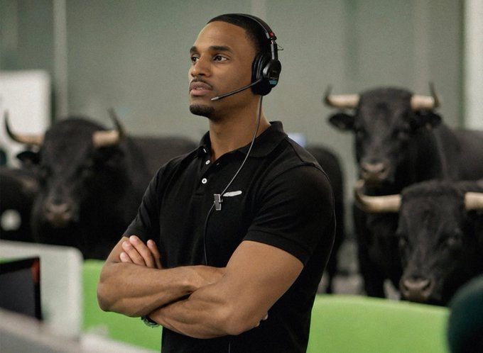 A man wearing headphones and a black polo shirt stands with arms crossed, surrounded by several black bulls with prominent horns, with a computer monitor visible in the foreground.

The image relates to the post by visually reinforcing the "bullish" sentiment: the man stands calmly and confidently among actual bulls, symbolizing the hope and optimism ("when the bulls finally return" or "when retail comes back"), while the text laments that this bull run will leave traders searching for the next big hype stock like $ANSEM—only to find none.