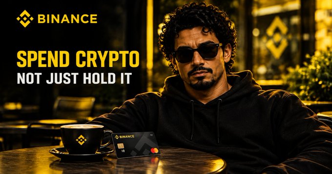 A Binance advertisement featuring a man in sunglasses with the slogan 'SPEND CRYPTO, NOT JUST HOLD IT' alongside a Binance coffee cup and card.