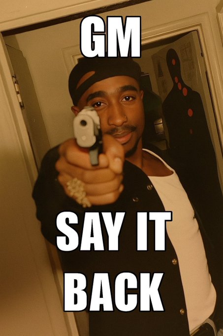 A meme image featuring a man pointing a silver handgun at the camera with the text 'GM SAY IT BACK' overlaid in bold white letters.