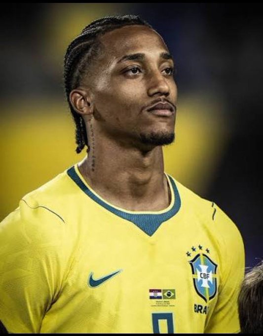 Brazilian football player wearing the iconic yellow CBF Brazil national team jersey with green trim.
