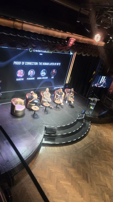 A panel discussion takes place on a stage at Credenciais.live with four speakers seated in chairs, discussing the topic 'PROOF OF CONNECTION: THE HUMAN LAYER OF NFTs' featuring guests Raanya, Pehrkine, Kernal Morgan, and Irze.
