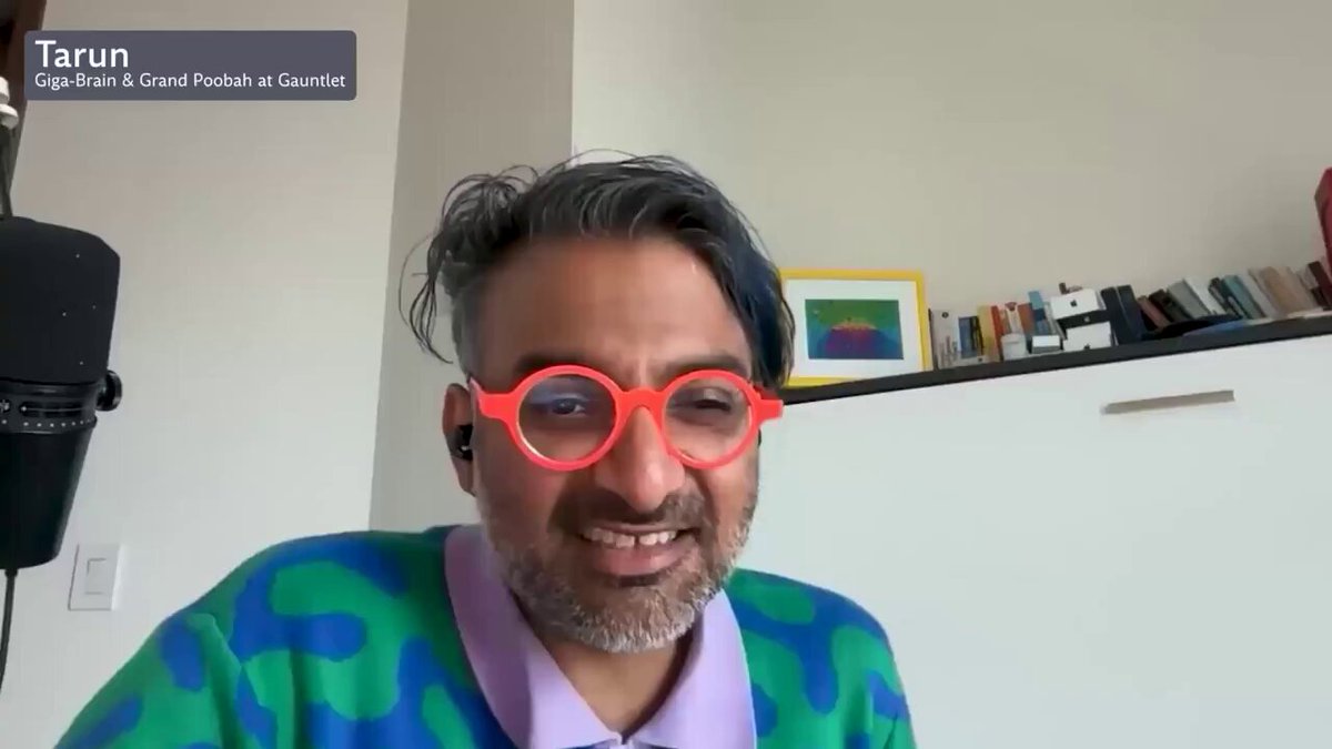 The image shows a man wearing glasses, possibly with red frames, sitting at a desk or table while talking into a microphone. The background features a bookshelf filled with various books, suggesting that he might be discussing the world of cryptocurrencies like Ethereum. The caption for the image reads "Ethereum is for boomers, but boomers hold the bag." This statement implies that the man in the image could be referring to the fact that older individuals are more likely to invest and hold onto cryptocurrency assets than younger generations.