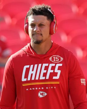 Patrick Mahomes of the Kansas City Chiefs is pictured wearing his red #15 jersey and red Beats headphones, standing in front of red stadium seats.
