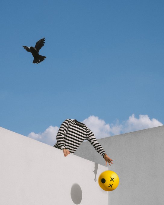 A surreal scene showing a person in a black and white striped shirt climbing over a white wall to reach a yellow ball with X eyes, while a black bird flies in the blue sky above.