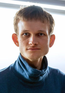 A young man with short brown hair and blue eyes, wearing a gray turtleneck sweater, looks directly at the camera with a neutral expression. The portrait likely depicts Vitalik Buterin, Ethereum's co-founder, whose recent commentary on prioritizing AI, privacy, and quantum resistance aligns with the accompanying news post about Ethereum's evolving strategic focus.