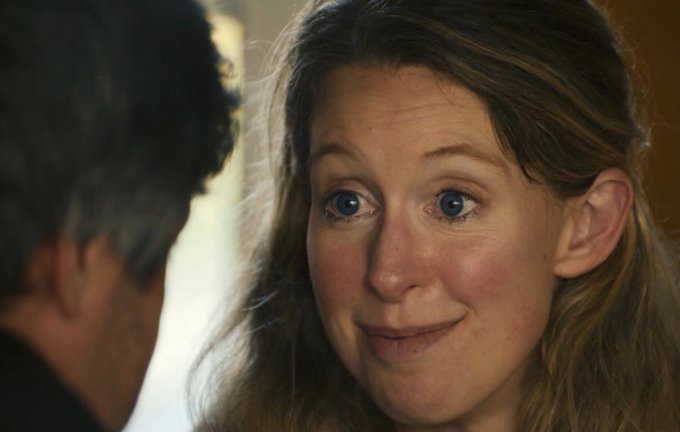 A woman with wide, hopeful blue eyes smiles nervously at a man, her expression suggesting she's seeking reassurance — fitting the post's question about whether her funds are truly safe while bridging across blockchains.