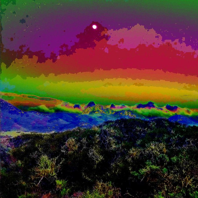A surreal landscape where a white moon rises over pixelated mountains under a sky fractured into vibrant rainbow bands, with the surrounding post noting the digital processing effect that transforms this nature photograph into blocky, colorful cloud formations, available at teia.art/objkt/883440.