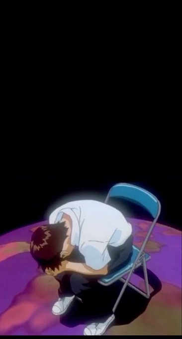 An anime-style image of a person with reddish hair sitting on a blue folding chair and hunched over with their head in their hands against a black background.